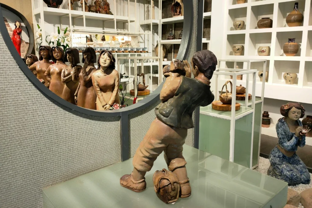 The Stoneware statue by Master Liu depicts a photographer taking pictures of a woman in a Qipao.