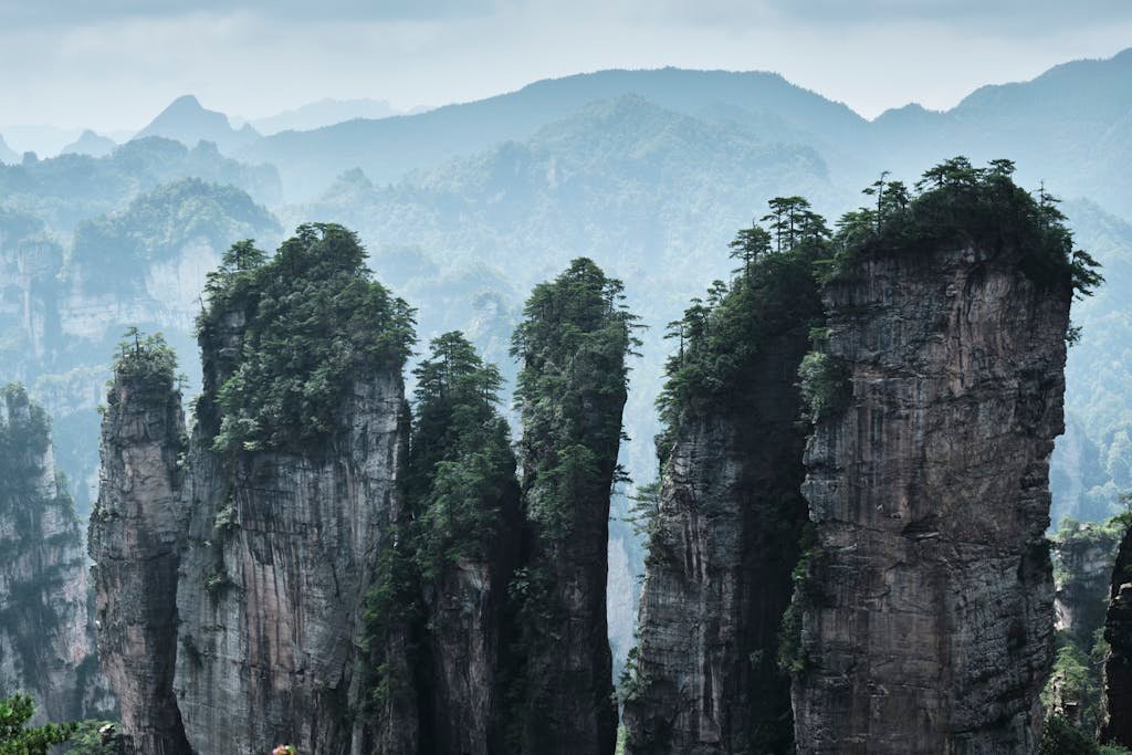 Explore the stunning natural beauty of Zhangjiajie's towering sandstone pillars.
